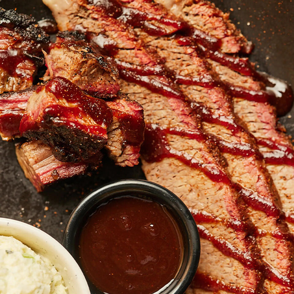 q39 bbq-close up image of a stack of ribs and bbq sauce