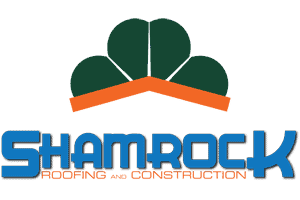 Shamrock Roofing and Construction logo with roof and shamrock design.