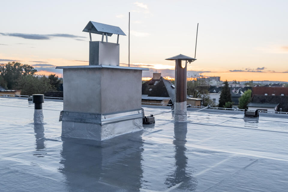 modified bitumen roofing-private house with flat roofing materials overlooking a neighborhood