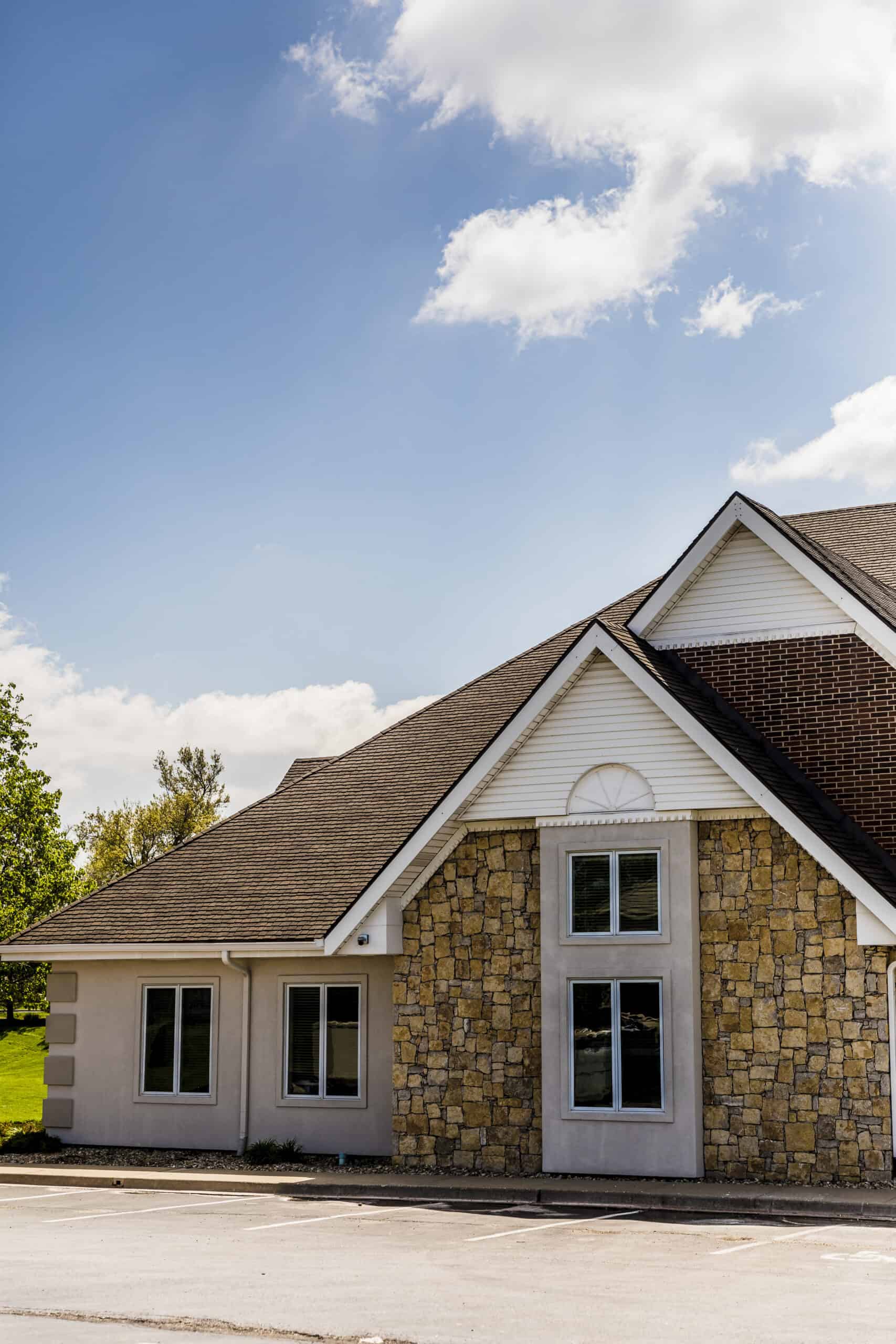 High-quality residential roofing with stone and vinyl siding by Shamrock Roofing and Construction.