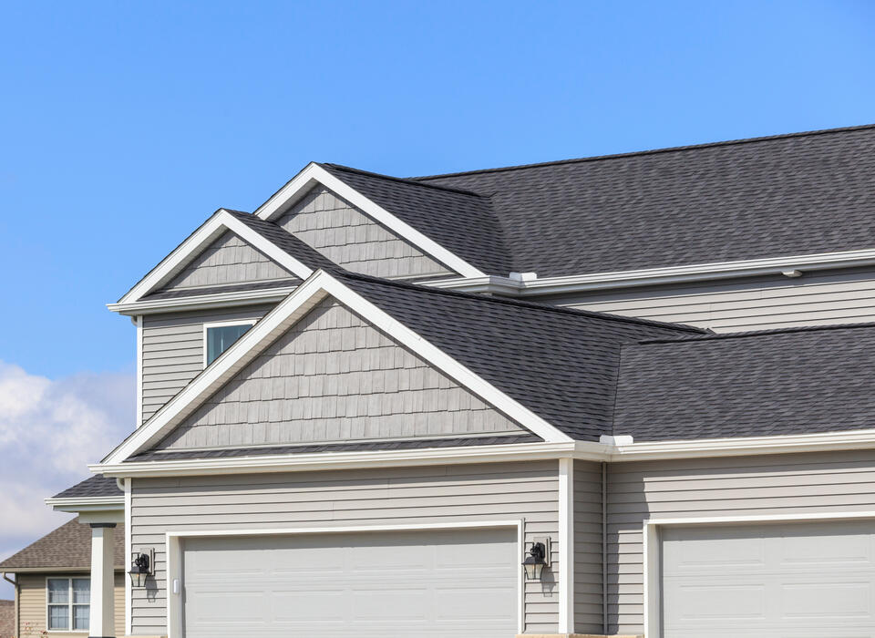 roofing chesterfield mo-light gray sided house with dark gray shingled roof