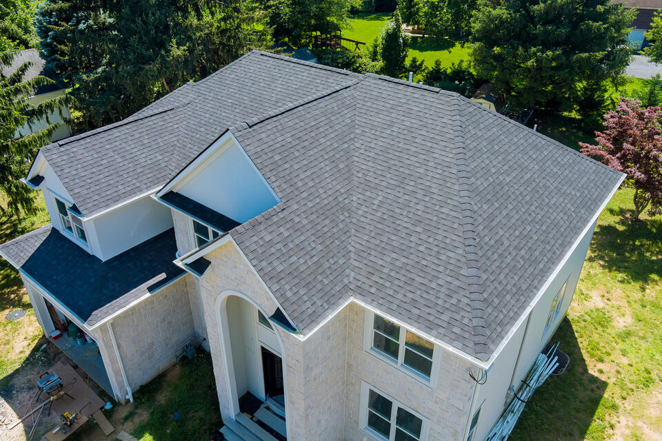 roofing clive ia-light colored house with gray shingled roof