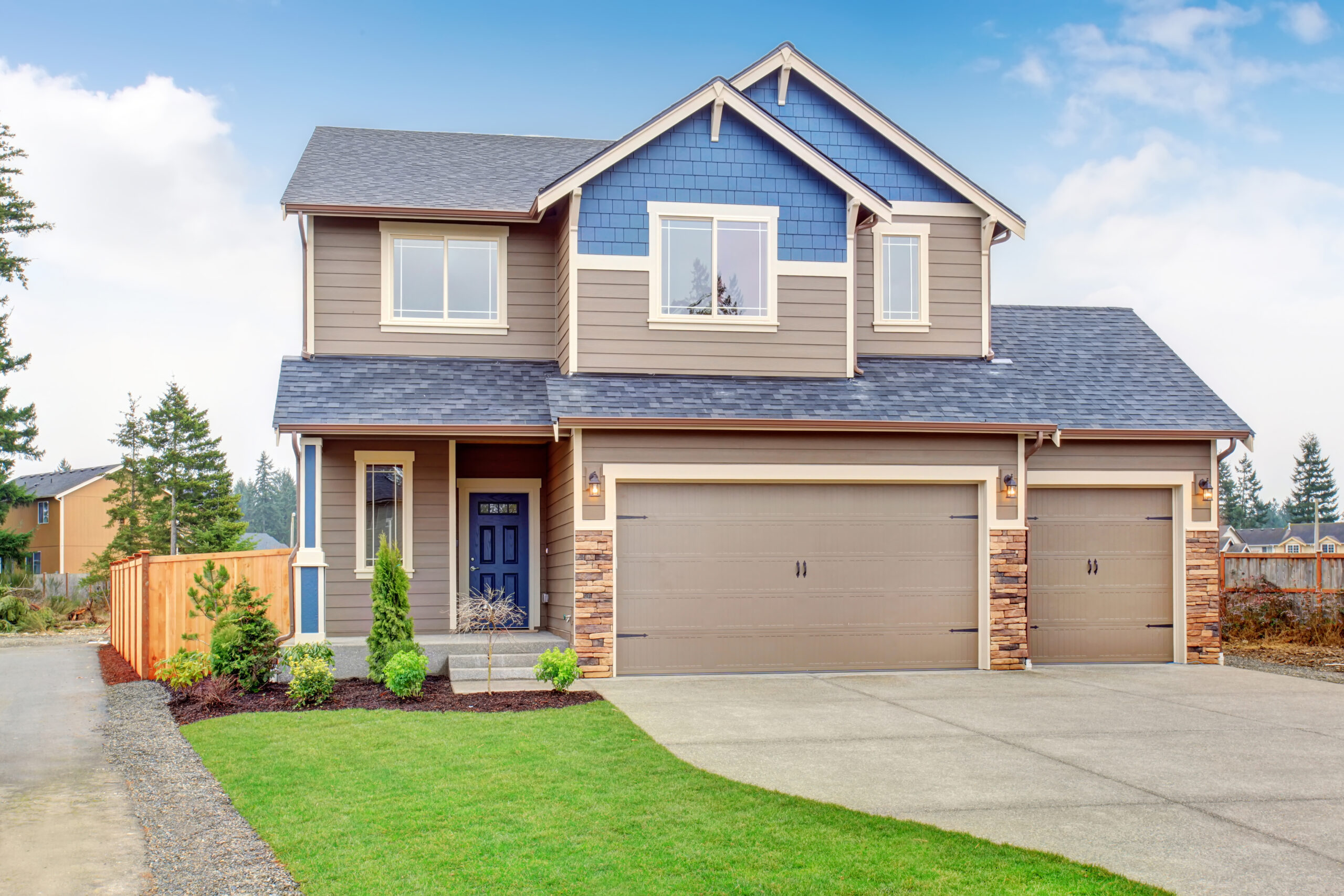 Beautiful traditional home with garage and driveway.