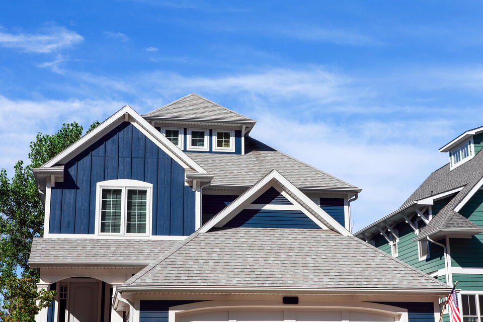 roofing st. peters mo-blue sided house with light gray shingled roof