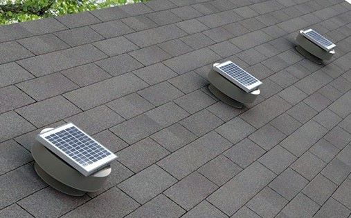 Solar-powered roof vents on asphalt shingles for energy-efficient roofing solutions.
