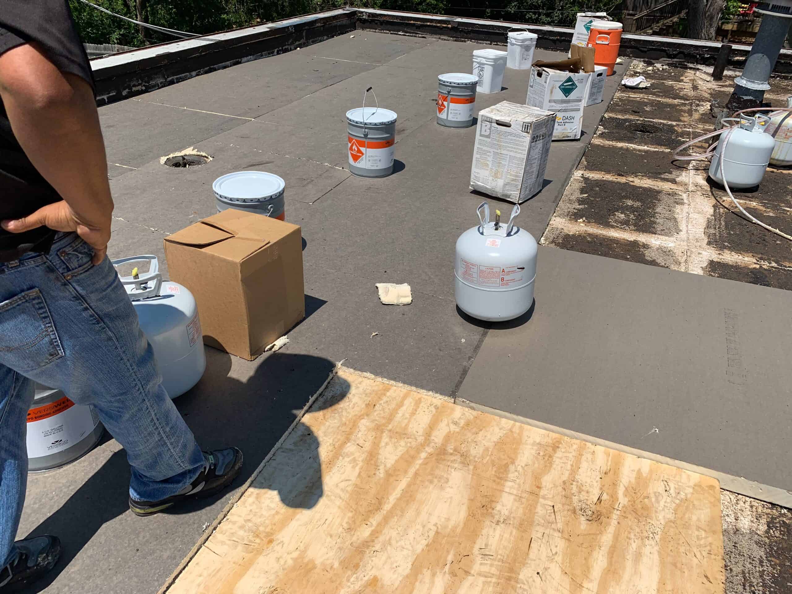 Roofing materials and tools on construction site, preparing for roofing project.