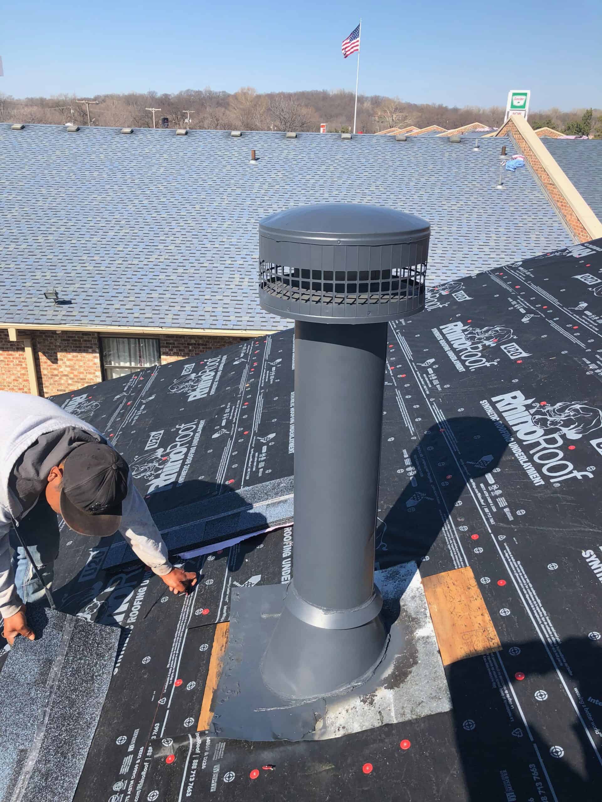 Vent pipe flashing installation on residential roof for proper ventilation and roof protection.