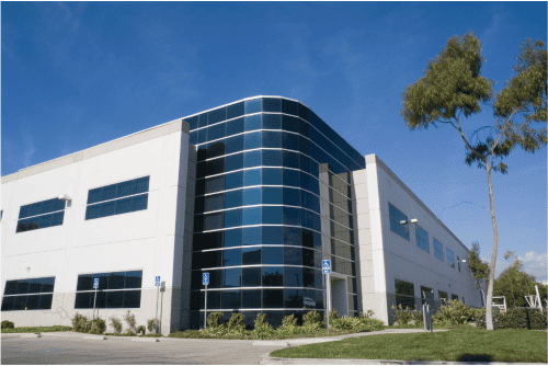 Modern commercial building with Shamrock Roofing and Construction services.