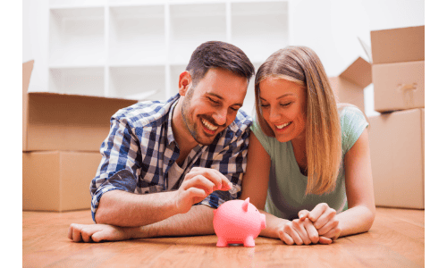 Piggy bank with couple smiling, home improvement and roofing services, happy homeowners saving money, Shamrock Roofing and Construction.