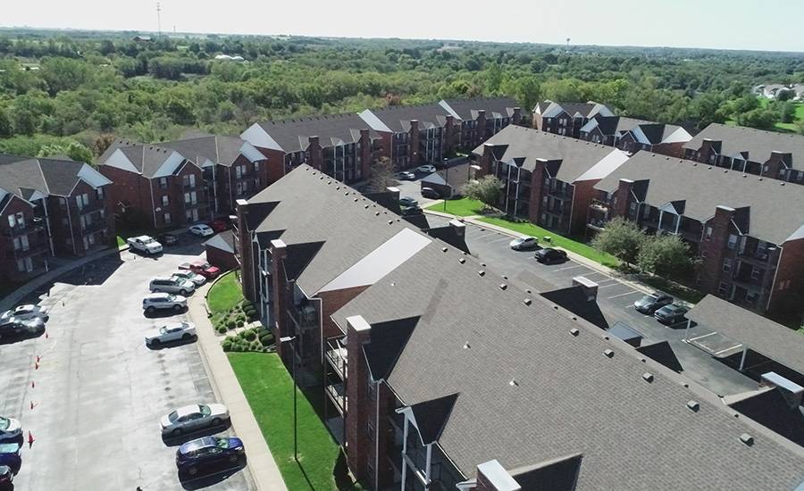 Roofing installation at apartment complex, Shamrock Roofing and Construction, quality roofing services.