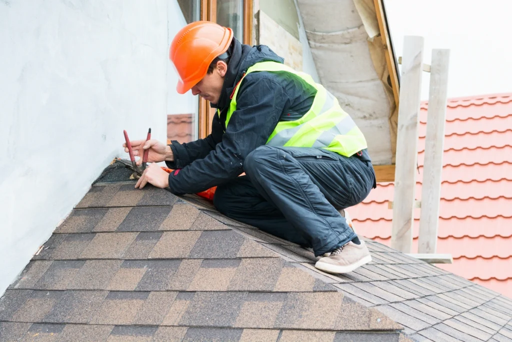 roofing contractor installing new shingles on a roof