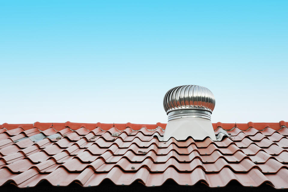 types of roof vents-turbine vent on a red metal roof