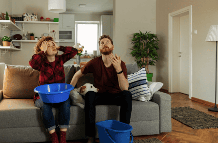 Broken pipe and water damage repair scene in a living room, emphasizing roofing and construction services.