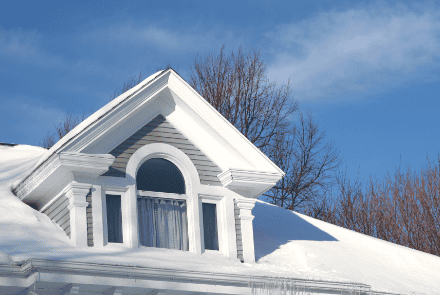 High-quality residential roof with snow on top, showcasing expert roofing services.