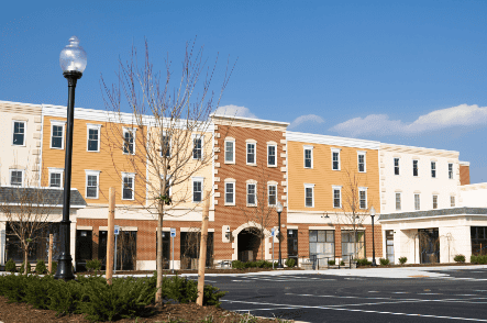 Modern multi-story commercial building with new roofing, siding, and construction services in a downtown area.
