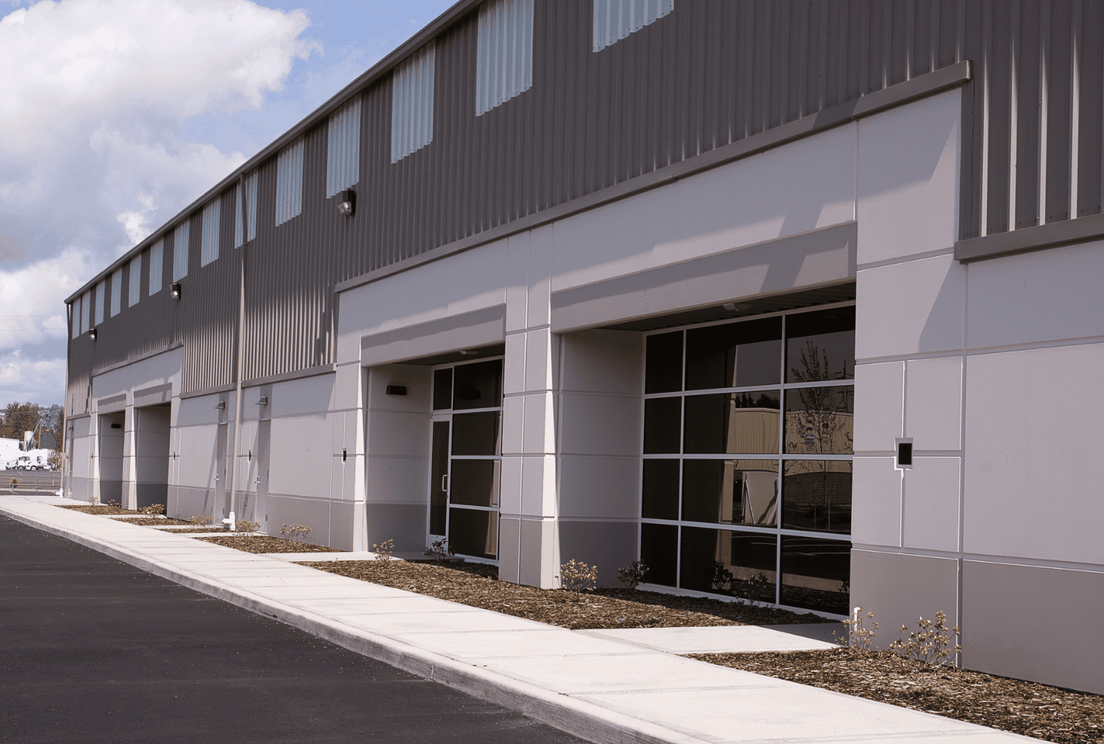 Metal commercial building with new roof installed by Shamrock Roofing and Construction.