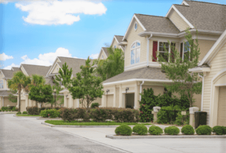 Modern residential neighborhood with well-maintained homes and lush landscaping, showcasing expert roofing and construction services.