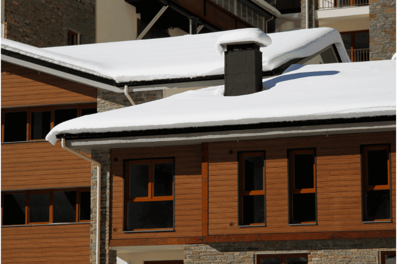 Snow-covered residential roof with durable roofing materials for optimal protection.