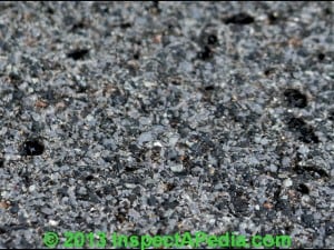 Black asphalt roofing shingles with granules for durable roofing solutions.