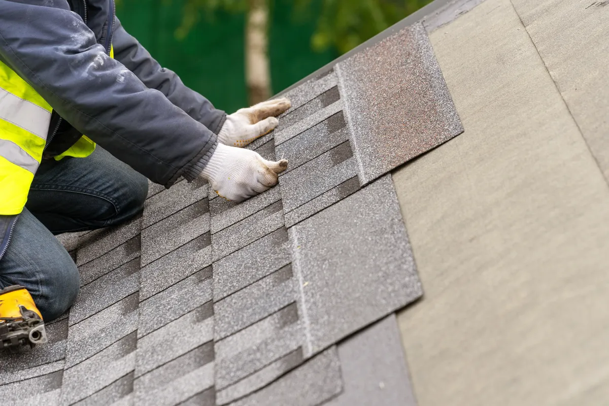 Installing new shingles on a roof in Papillion