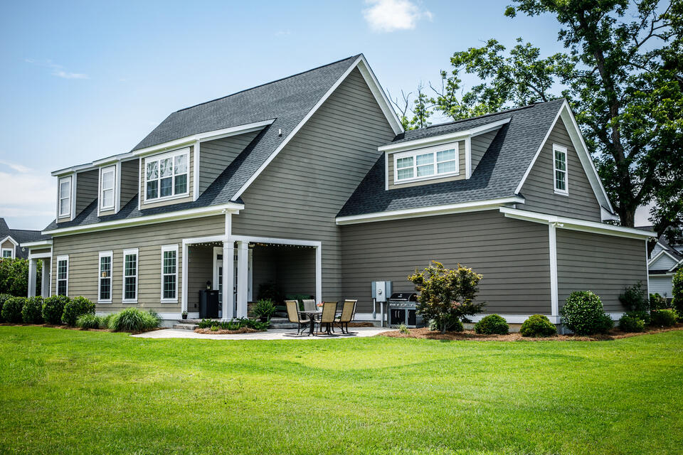 hip roof vs gable roof-suburban home with gable roofing and gray shingles