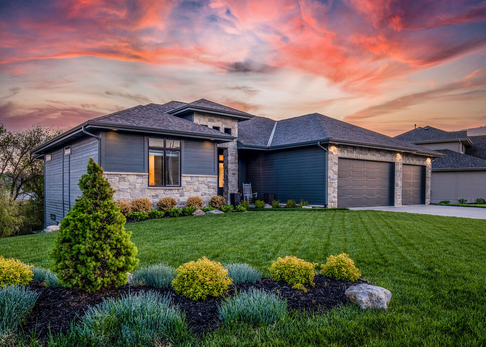 hip roof vs gable roof-suburban home with hip roofing and dark shingles