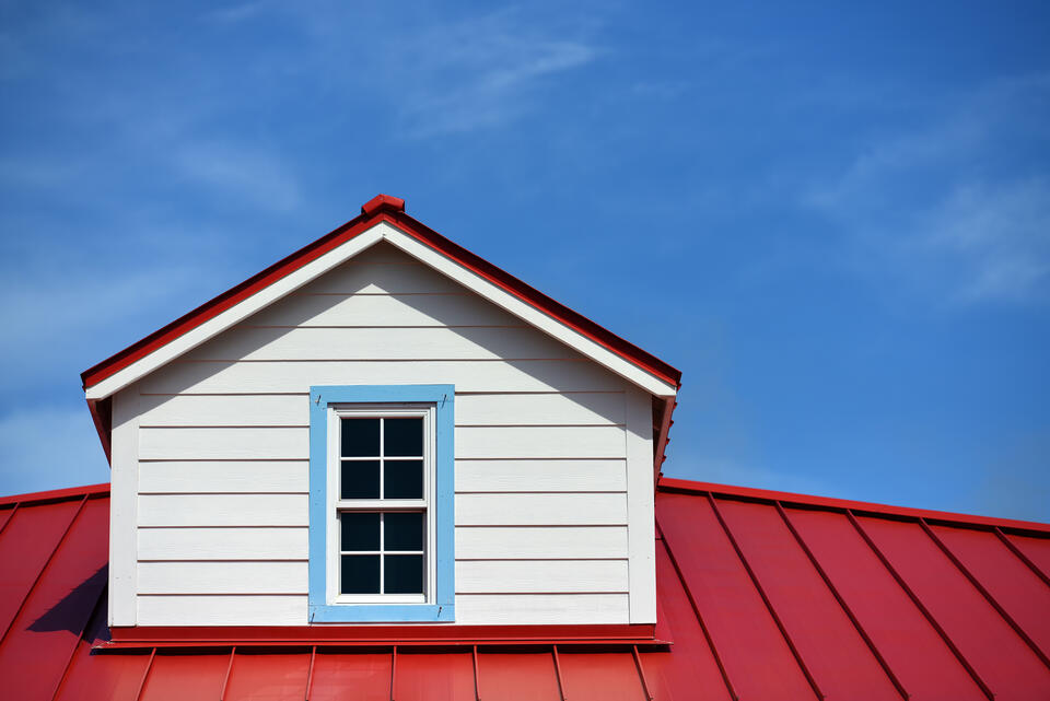 metal roofing colors-close up of red standing seam metal roof on a house