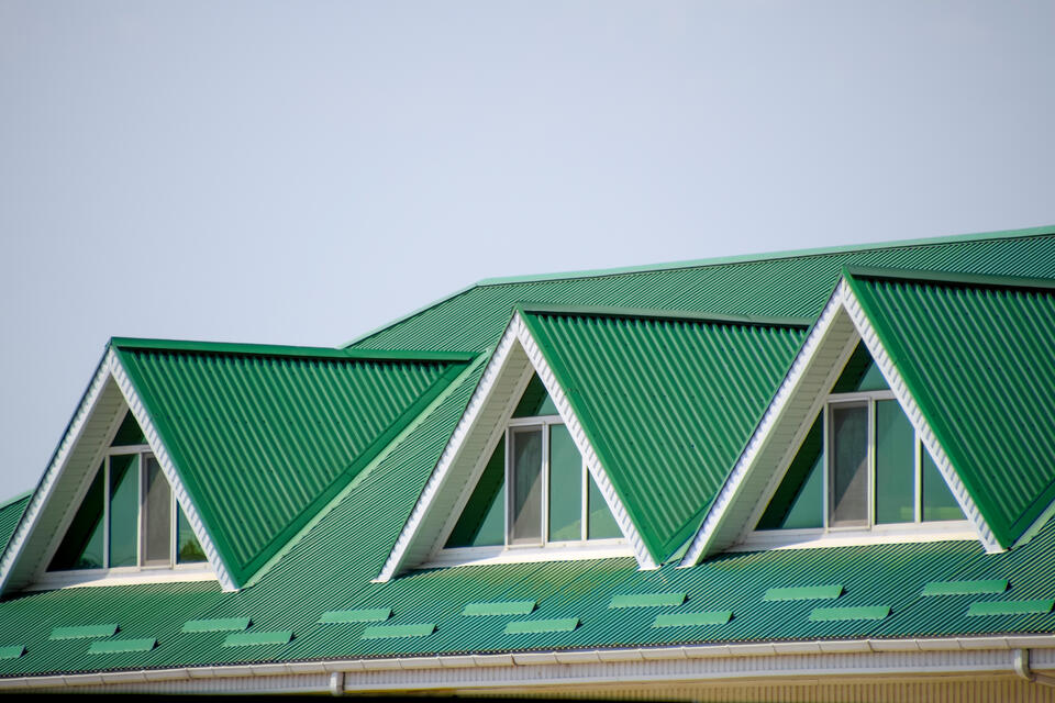 metal roofing colors-house with green corrugated metal roofing