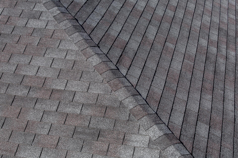 best roofing shingles-close up of gray 3 tab shingles on a house roof