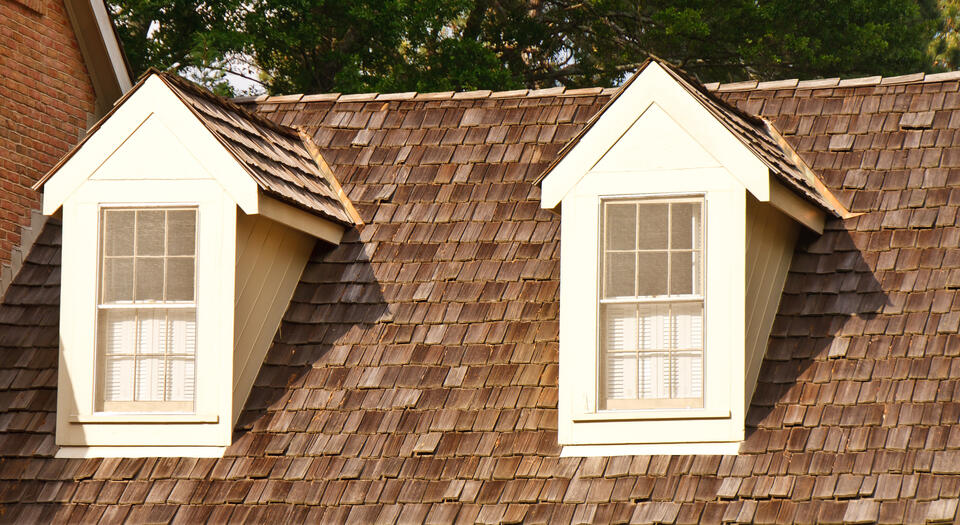 best roofing shingles-wood shingles on a white sided house