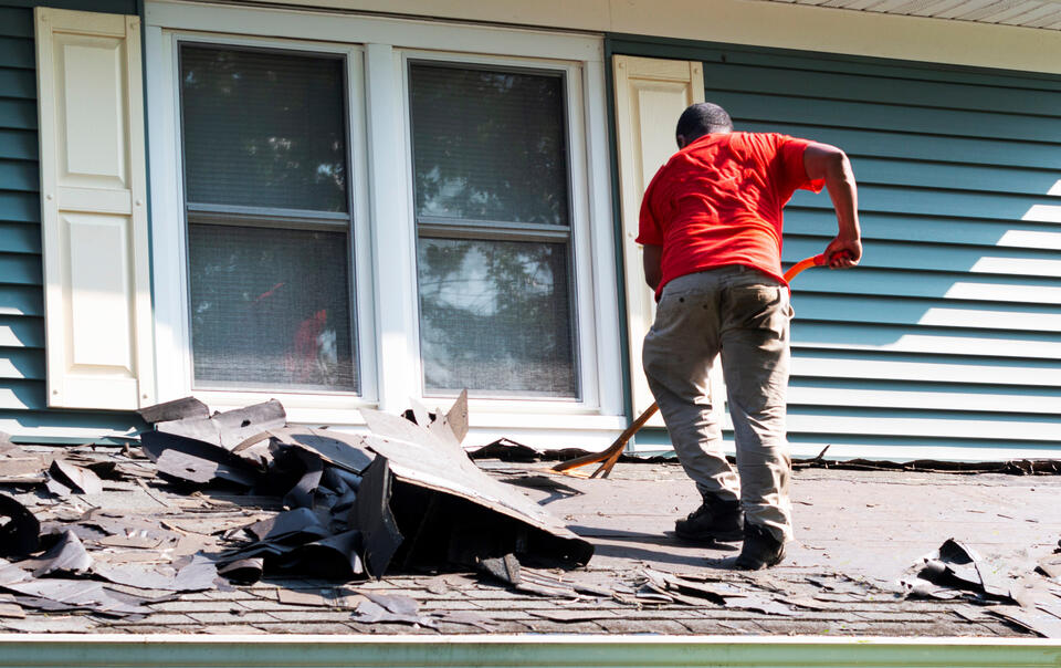 how long does it take to replace a roof-roofer removing old roofing shingles on a home