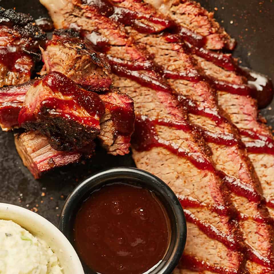 q39 bbq-close up image of a stack of ribs and bbq sauce